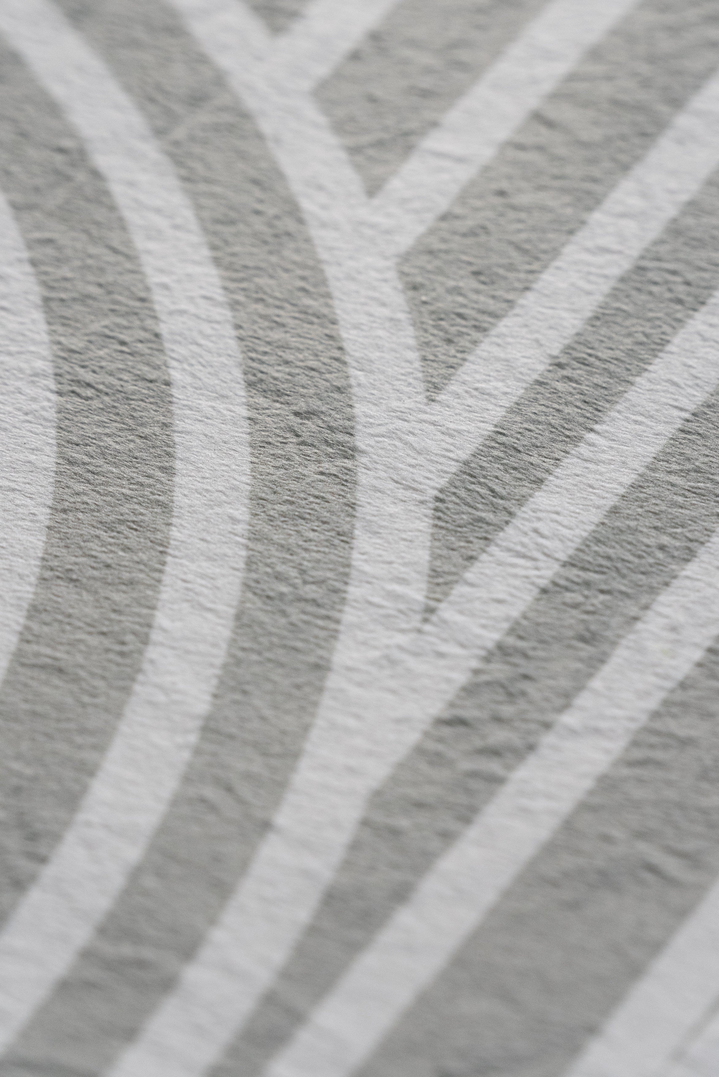 A close-up view of a textured pattern featuring shades of white and grey.