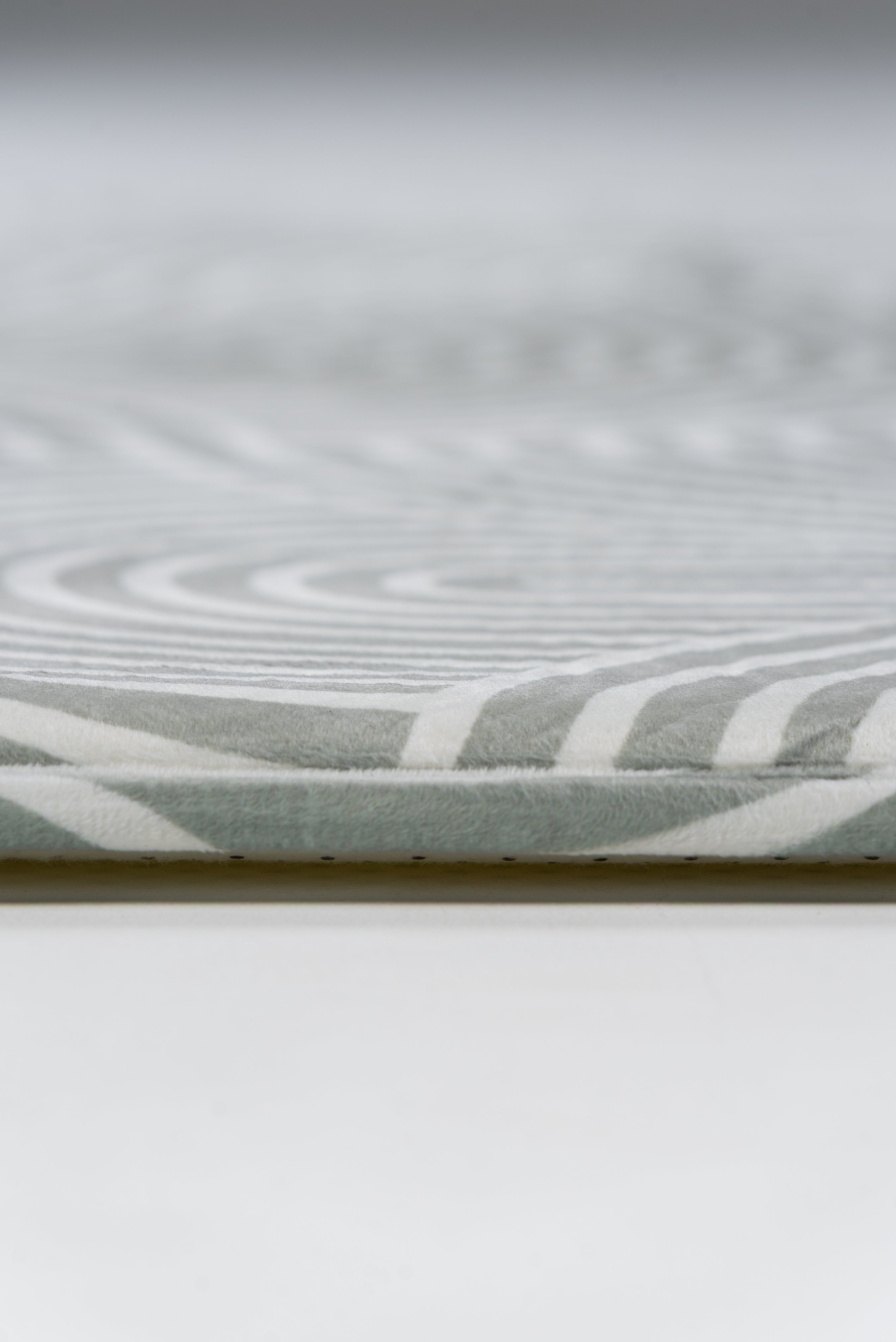 Detailed view of a white and grey patterned surface, showcasing intricate textures and soft color contrasts.