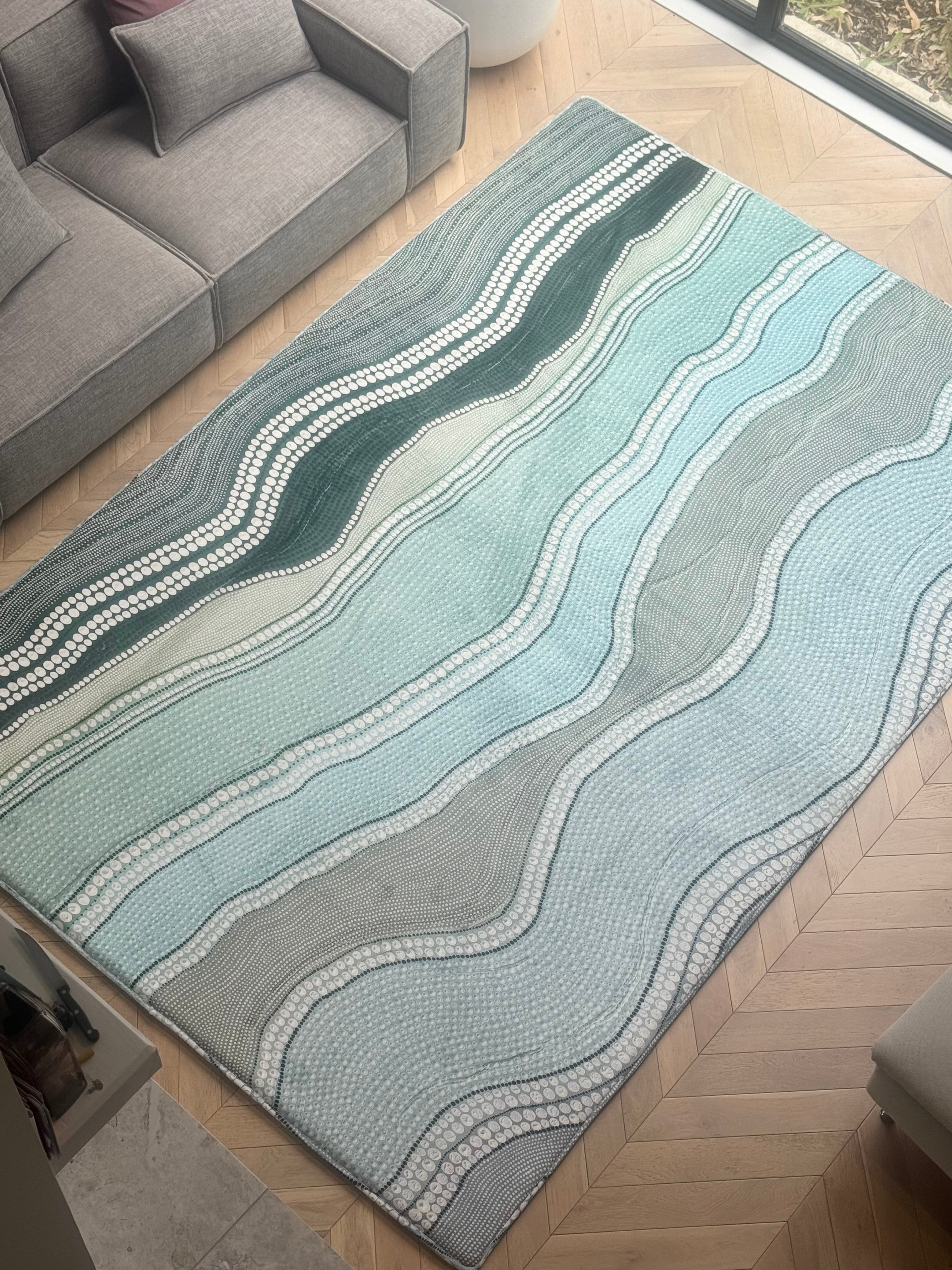 A living room featuring a rug with a wave pattern, adding a dynamic touch to the cozy space.