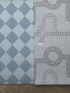 A white and blue checkered rug with a classic pattern, positioned in a bright living space.