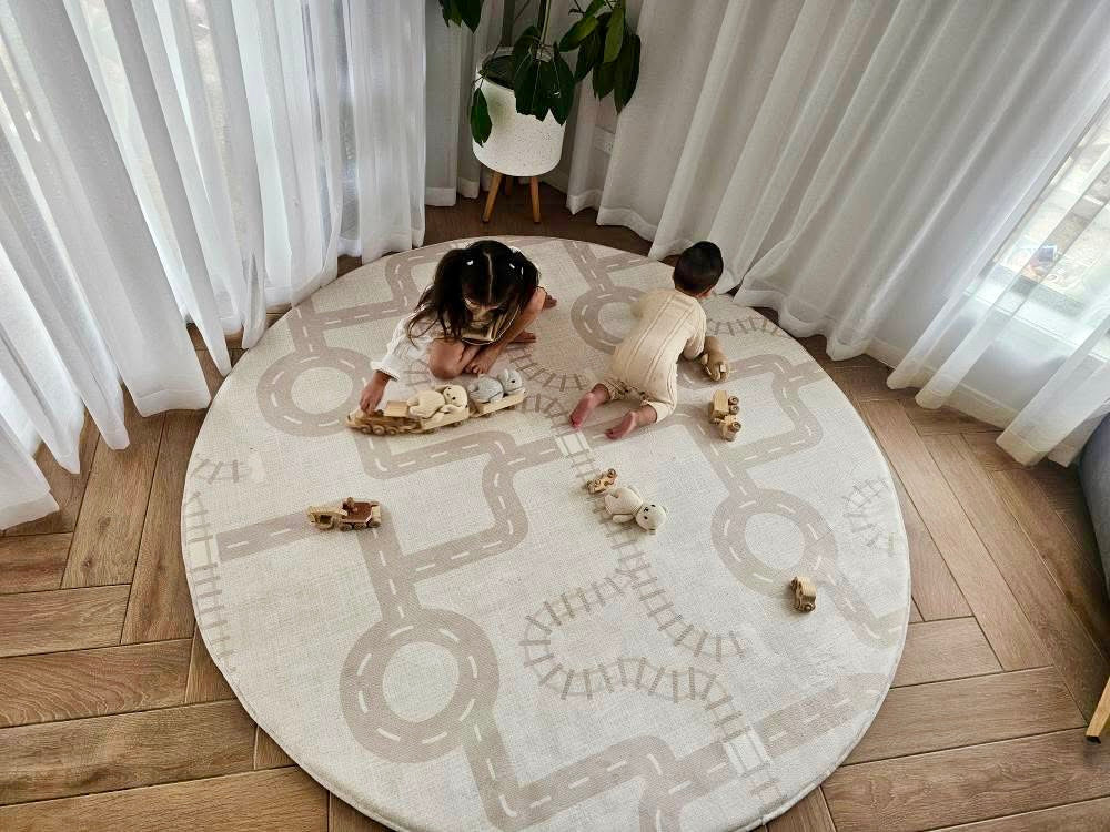 Round plush activity memory foam rug in neutral tones with road print