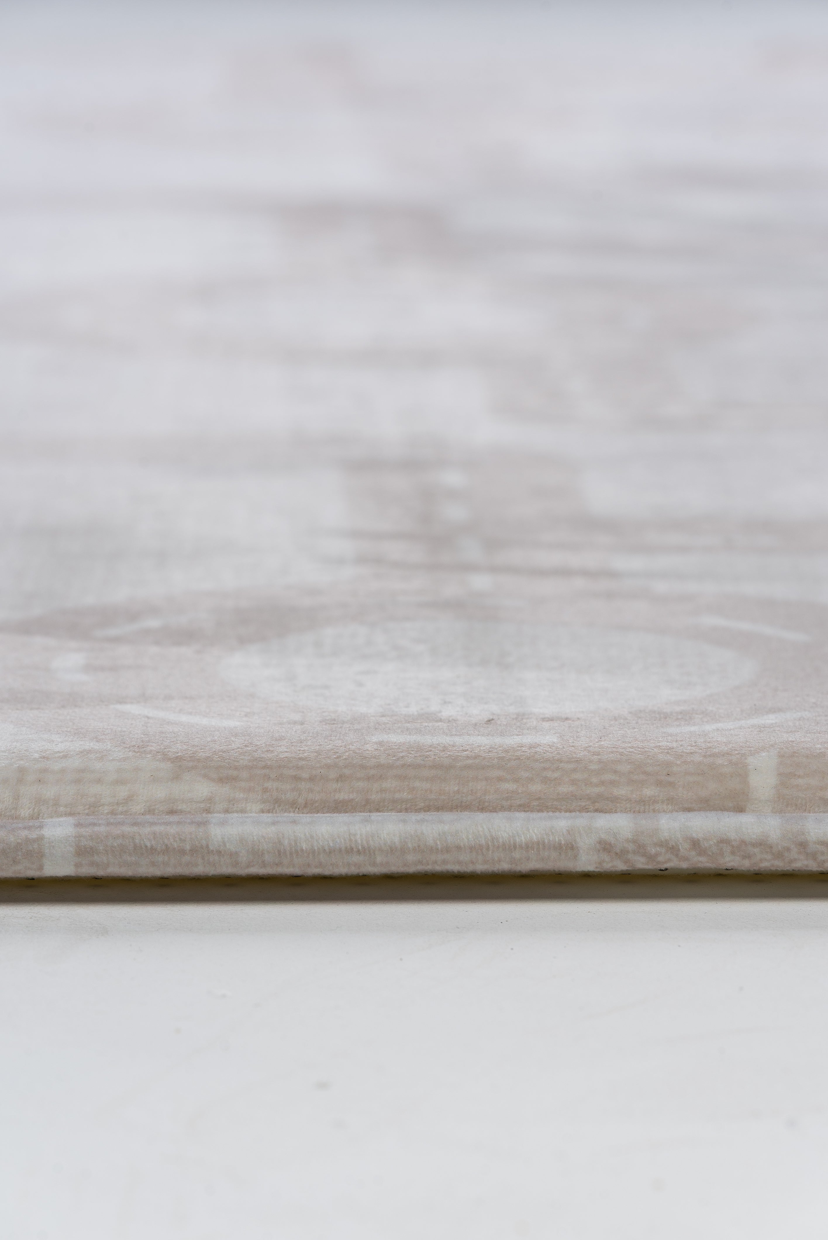 Close-up of a white table featuring a smooth, white surface, highlighting its minimalist design and clean aesthetic.