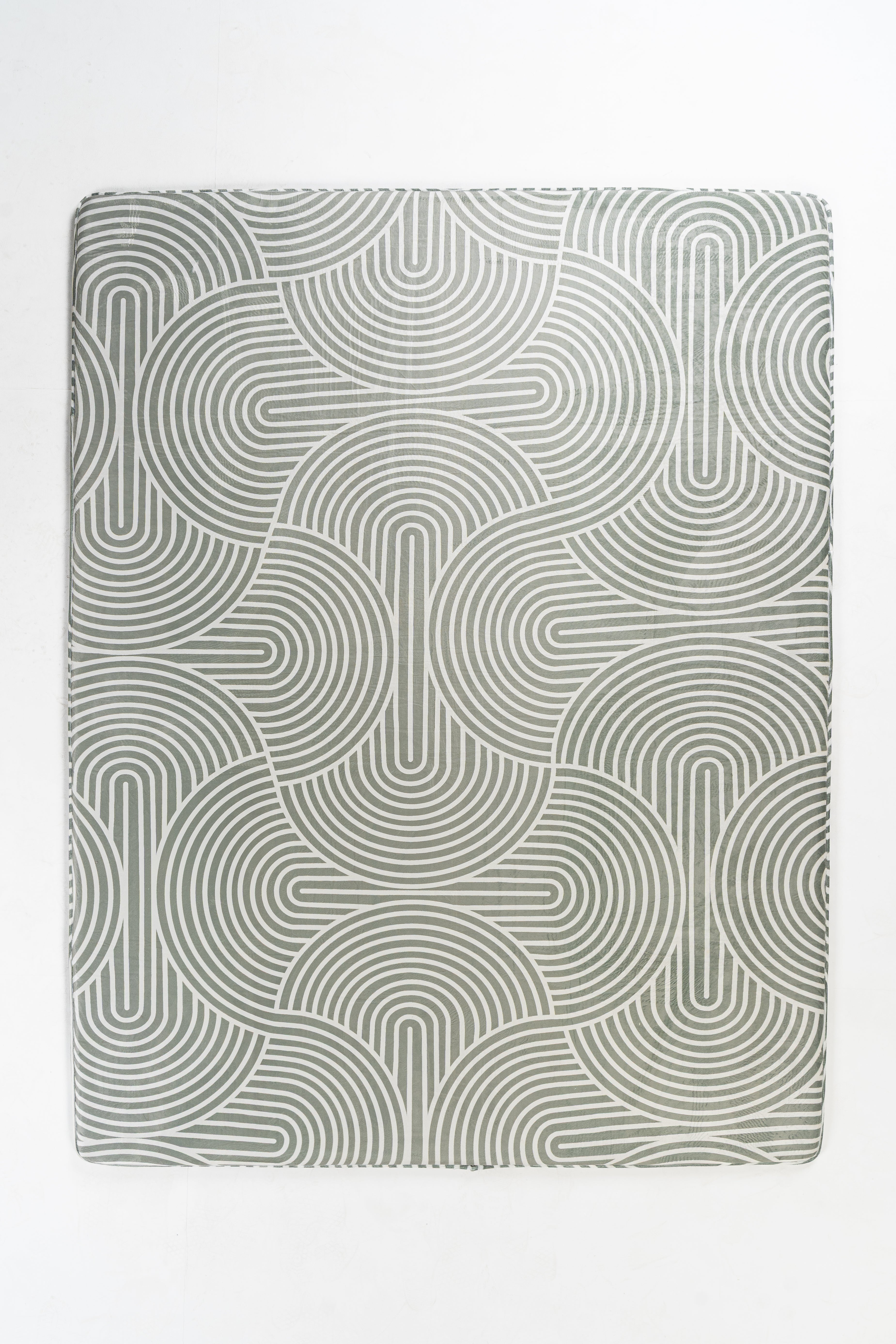 Gray rectangular placemat with a repeating pattern of concentric, arched lines.